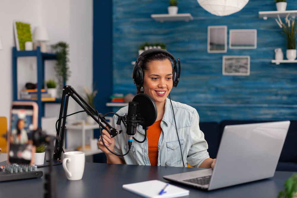 Podcast Marketing - social media influencer looking at laptop and recording video. woman vlogger streaming online podcast